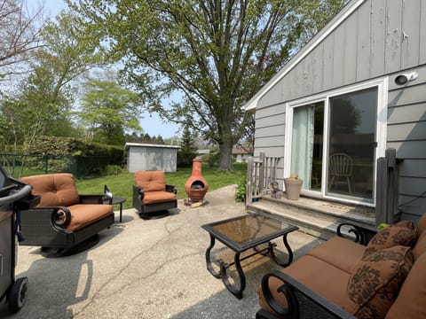 Comfortable outdoor patio off the kitchen/dining area of the house + gas grill.