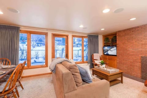 Bright and spacious living room with fireplace and large floor-to-ceiling windows