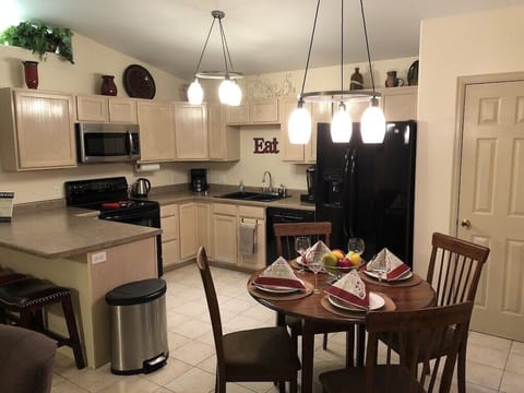 Kitchen adjoins living room. Open & well-lit. Seats 6.