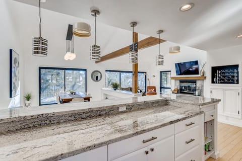 Dining and living area view from kitchen and breakfast bar.