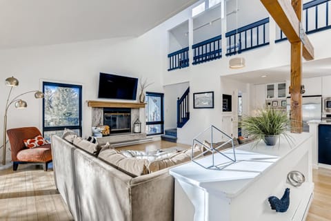 Living room showing stairs that lead to upper level.