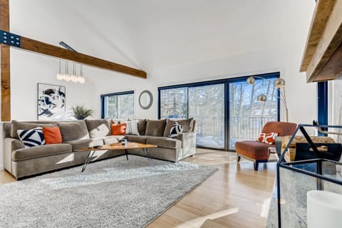 Living room with 2 large sliding glass doors out to the expansive deck.