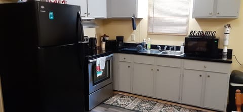 Fridge, microwave, stovetop, coffee/tea maker