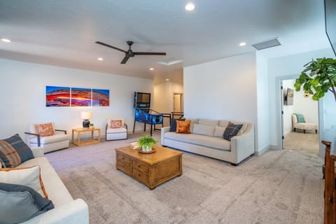 Spacious upstairs living room with comfortable seating, a smart TV, and an arcade
