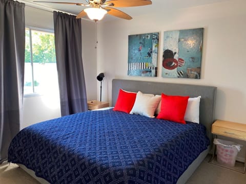 second bedroom with king bed. Window looks out to pool