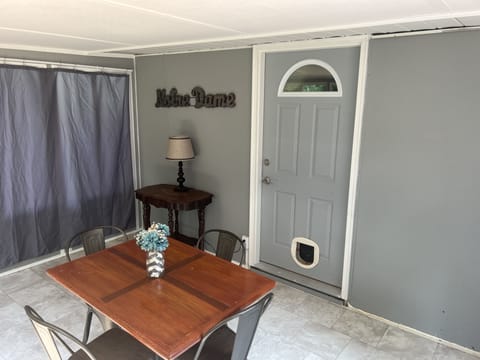 Enclosed back porch off of twin bedroom and patio. Seating for 4. 