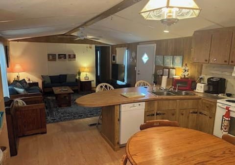 View of living room from kitchen. Kitchen table seats 6 and extension if needed.