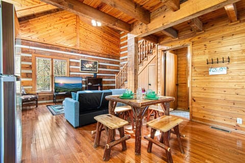 Dining & living room, stairs to the loft bedroom, and the bathroom door on the right.
