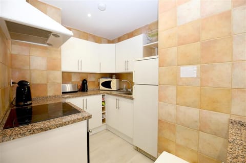 Open kitchen in this apartment is very well equipped 