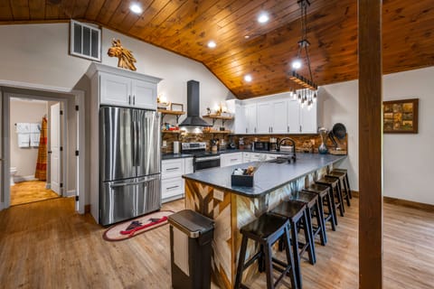 Our kitchen with 8 bar seats is your culinary haven. Unleash your inner chef and create memorable moments with a side of mountain charm.