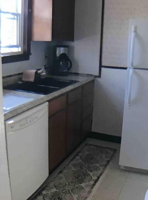 Kitchen. Can see dishwasher, coffee maker and refrigerator.
