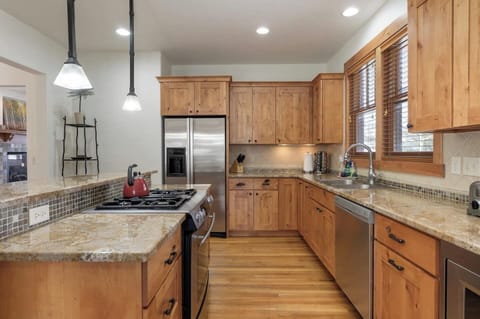 Island with 3 bar stools, built in desk, Jenn-air fridge, double basin sink, Frigidaire dishwasher, 4 gas burner stove with oven, Keurig coffee maker, toaster, blender