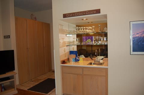 Wet bar area with games and supplies below (BYOB).