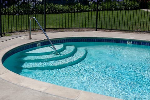 A heated pool, sun loungers