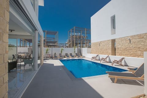 Outdoor pool, a heated pool, sun loungers