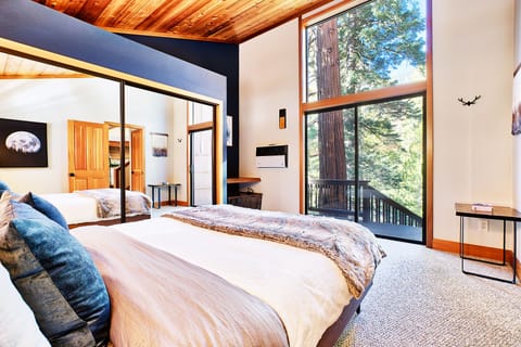 The lower bedroom has views of the beautiful forest just outside.