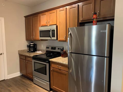 Lots of cabinets, stocked with kitchenware! Stainless steel appliances.