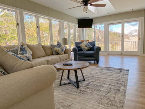Windows all around Sunroom and Living Area off of Open Kitchen and Dining.