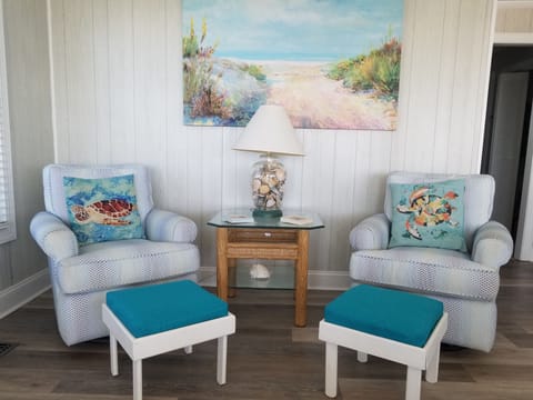 Comfortable seating area with views of the beach and dunes.