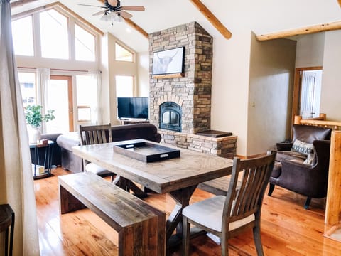 Large, rustic dining table seats 8. There are 4 bar stools at the kitchen island