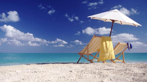 On the beach, sun loungers, beach towels