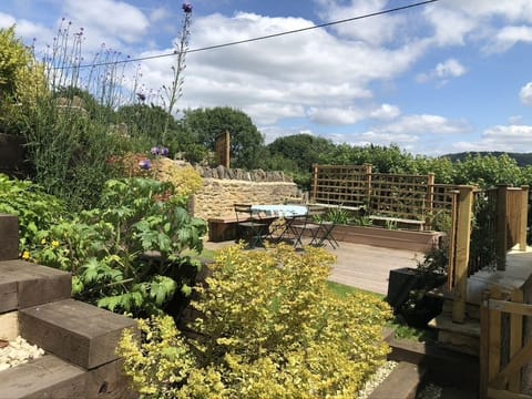 Decked area outside with a coal BBQ