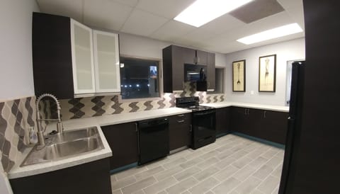 New kitchen with dishwasher, microwave, stove and refrigerator.