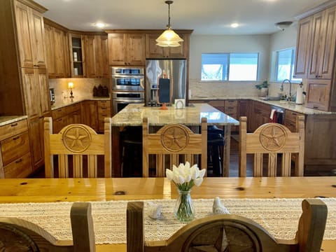 Open kitchen with plenty of room! Dining table seats 8 + 6 around island.