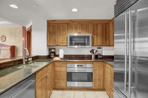 Fully equipped kitchens with stainless steel appliances.