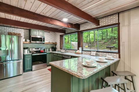 Huge kitchen with stainless steel appliances and granite countertops.