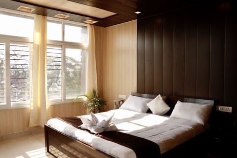 Bedroom 1: large windows, king-sized beds.