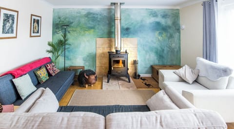 comfortable spacious living room with views to village and hills beyond