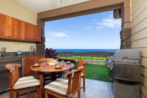 Covered lanai with ocean views and seating for four