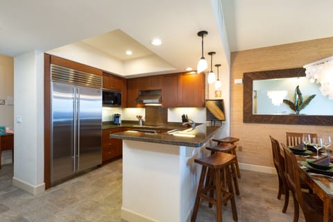 Fully equipped kitchen with breakfast bar, granite counters and stainless steel appliances