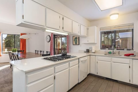 Open and bright kitchen with built in gas cook top