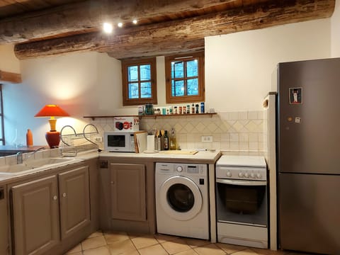 Kitchen with gas stove, micro wave, washing machine and new fridge-freezer. 