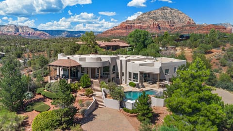 Iconic Sedona Views from a Private Luxury Estate- Perched high above the red rocks, this stunning estate offers unmatched privacy and panoramic views of Cathedral Rock and Thunder Mountain.