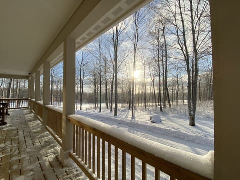 Sip coffee or hot cocoa from the porch and watch the snow fall in the woods!
