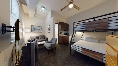 This unit features carpet throughout, there is a queen over XL full bed bunk bed, a separate wardrobe, and dresser for hanging and storing clothes, plus comfortable seating. The place is Seconds to Orange Line and Silverline.