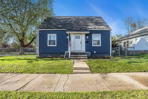 Front of house; well-lit entryway with small garden beds.