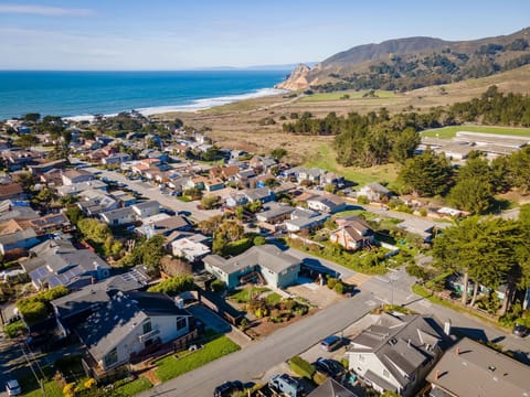 Aerial view of the house, neighbourhood, nearby beach