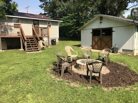 Backyard area, fire pit and out building sitting area.