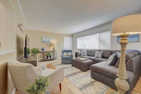 Living Room: Brightly lit living room with a view of the bay. Features a sectional sofa bed that makes into a queen bed plus a comfy swivel rocking chair.