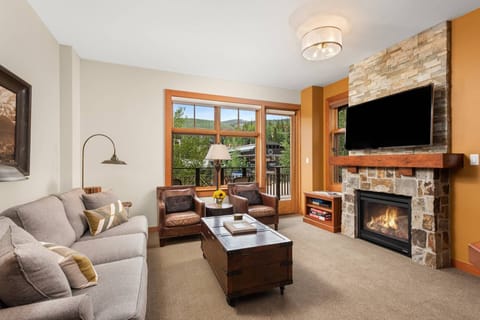 This bright and welcoming living area, with view of the Snowmass Gondola, features a pull-out sofa bed, flat screen TV