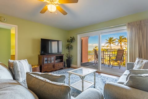 Living room and balcony overlooking the pool, tennis courts and Gulf views!