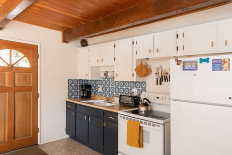 Fully equipped kitchen with electric stovetop and oven