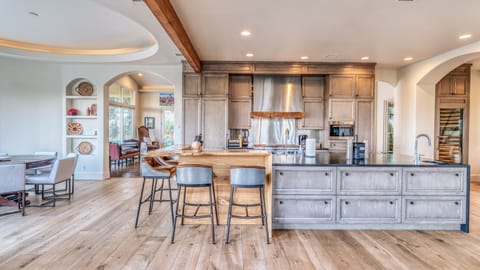 Gorgeous farmhouse style kitchen w/ large island, bar seating & dining room