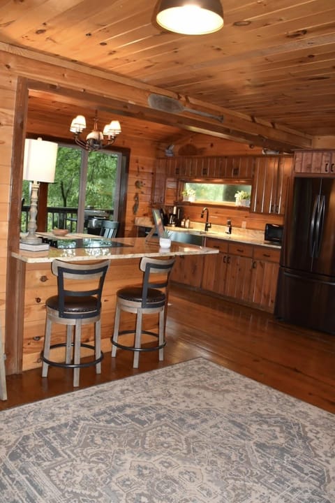 The kitchen with bar seating and a table for 4