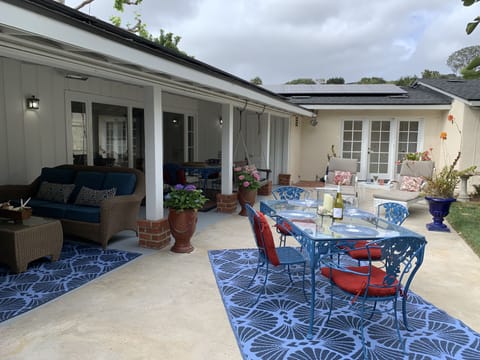 Big back yard with lush landscaping and lots of out door seating