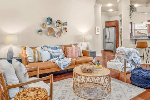 Cozy living room with comfy couch and chairs with lamps and coffee table.